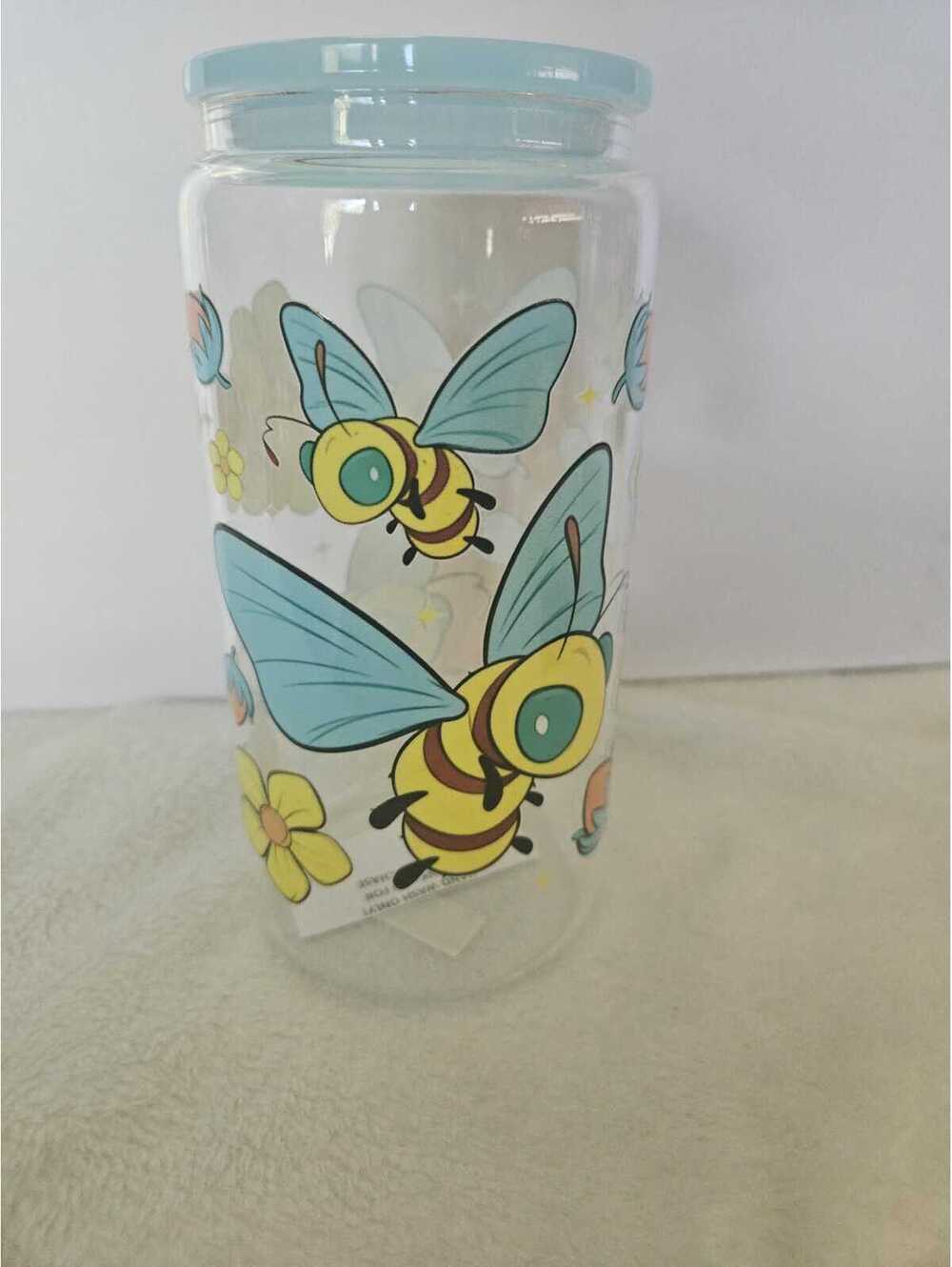 16 oz glass cup with acrylic Lid. Comes w/ straw and straw cleaner.